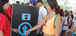 A concert-goer scans her wristband for entry to an event.